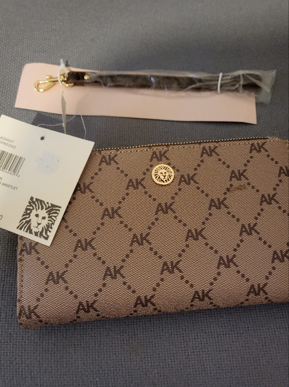 1 HOUR SALE NWT ANNE KLEIN /Tan Monogram Canvas Wristlet with Gold Medallion